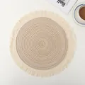 Detail shot of a round ramie placemat with fringe edges on a minimalist dining table - Beige with Tassels
