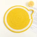 Close-up of lemon-shaped woven placemat with yellow spiral pattern and side loop - S / Lemon
