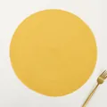 Top view of yellow round ramie placemat with spiral woven texture and gold fork - Solid Yellow
