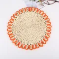 Detail showing handcrafted round woven placemat with orange scalloped edge - Sunflower Orange Border