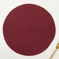 Detail of burgundy woven ramie placemat with a spiral texture and a golden fork - Solid Dark Red