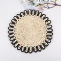 Close-up of a round corn husk placemat with spiral weave and black scalloped edges - Sunflower Black Border