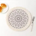 Top view of bohemian woven cotton coaster with gray leaf mandala print and fringed edges - Creative Pattern 7