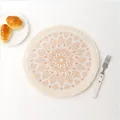Detail view of woven mandala coaster with orange fringe and bohemian floral pattern - Creative Pattern 10