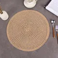 Top view of a round woven jute placemat on a dark stone table with tableware - 38cm / Brown
