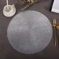 Detailed texture of silver round hollow PVC placemat with coral vein design on table - Alice (Silver)