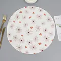 Detail of round woven placemat with floral daisy print and heat-resistant spiral texture - Pattern 4