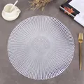 Close-up of silver hollowed round PVC place mat with elegant concentric patterns - Raindrop (Silver)