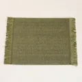 Macro shot of green woven paper placemat showing herringbone texture and fringed edges - 45*30cm / Green Paper