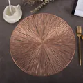Detail of round rose gold cutout placemat with radial lines on dark textured surface - Fireworks (Rose Gold)