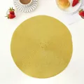 Close-up of a yellow woven round placemat with spiral texture on a dining table - 38cm / Bright Gold