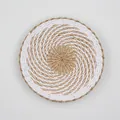 Detail of hand-woven natural straw and white fiber wall decor with spiral texture - A19