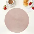 Macro detail of pink hand-woven round placemat showing spiral texture and craftsmanship - 38cm / Champagne