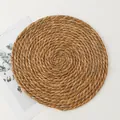 Handwoven round grass placemat made of natural plant fibers with spiral weave texture - Basic (30)