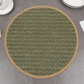 Detail of round moss green woven placemat with natural cork edge on a dinner table - 38cm / Green