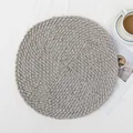 Handwoven circular grey paper fiber placemat with spiral pattern and reinforced center - Light Gray