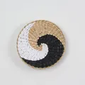 Round woven wall decor featuring a black and white spiral bohemian pattern - A8