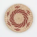 Handwoven wall decor with a natural straw and deep red spiral pattern in a bohemian style - A20