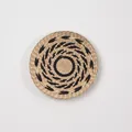 Minimalist boho wall decor in circular woven straw with black spiral pattern - A21