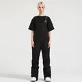 Women's black waterproof ski bib overalls with functional cargo pockets and adjustable straps - XS / Bottoms / Black