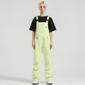 Women's neon green waterproof ski bib overalls with adjustable black straps and pockets - XS / Bottoms / Light Yellow