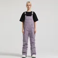 Women's lavender waterproof ski bib pants with adjustable straps and front pockets - XS / Bottoms / Light Purple