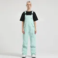 Waterproof mint green ski bib overalls for women featuring multi-pocket design and straps - S / Bottoms / Light Blue