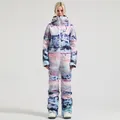 Women's one-piece ski suit featuring blue and pink mountain landscape print for winter sports - Rainbow