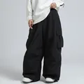Oversized black waterproof ski pants featuring side cargo pockets and a baggy fit - XS / Bottoms / Black