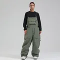 Loose fit olive green waterproof ski bib trousers with multi-pocket workwear design - XS / Bottoms / Army Green