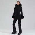 Slim-fit women's one-piece black ski suit with faux fur trim and functional belt - XS / Top And Bottom / Black