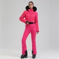 Women's pink ski suit with V-quilted jacket, black fur hood and matching slim-fit pants - Rose Red