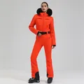 Women's one-piece ski suit in bright orange with black fur collar and waist belt - Orange Red