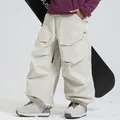 Cream colored waterproof cargo ski pants with large side pockets and elastic cuffs - XS / Bottoms / Off White