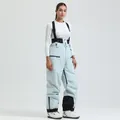 Insulated light blue ski bib pants with black suspenders and multiple zipper pockets - Light Blue - Women