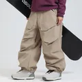 Khaki oversized cargo ski pants with waterproof fabric and multi-pocket design - XS / Bottoms / Khaki