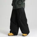 Waterproof black loose fit ski pants with zippered cargo pockets for outdoor skiing - XS / Bottoms / Black