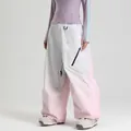 Waterproof oversized ski pants featuring a pink and white patchwork design for outdoor sports - XS / Bottoms / Beige Pink Gradient