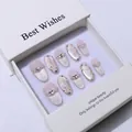 Macro view of handmade pink cat-eye press-on nails with silver butterflies and pearls - XS / Medium Oval
