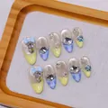 Unghie finte artigianali francesi con fiocchi blu, cristalli e glitter cat-eye - XS / Segreto Blu - Forma a Mandorla