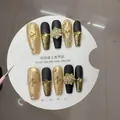 Handmade press-on nails with rotating snowflakes and gold foil in matte black finish - XS / Rotating Snowflake Medium Coffin (A05)
