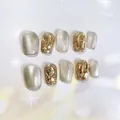 Handmade press-on nail kit featuring sparkling cat-eye effect and champagne gold rhinestones - XS / Rina-New Short Coffin (S60)