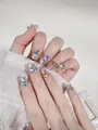 Detailed view of handmade press-on nails with luxury colorful rhinestones and 3D gems - XS / Candy Soda - Short Coffin (F16)