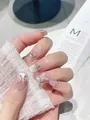 Detail von handgefertigten Kunstnägeln mit 3D-Schmetterlingen, Perlen und Cat-Eye - XS