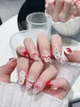Detail of handmade press-on nails featuring 3D red bows, polka dots, and silver glitter - XS / Rina Skirt - Short Oval (F42)