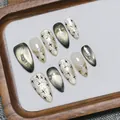 Sparkling gold cat eye press-on nails with black star design and pearl accents - XS / Gold Cat Eye Almond Shape (T385)