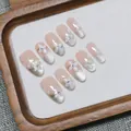 Handmade cat-eye press-on nails in oval shape with 3D white floral decor and pink base - XS / Medium Oval