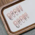 Handmade press-on nails featuring pink cat-eye gradient design with butterfly and rhinestones - XS