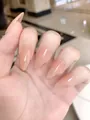 Close-up of nude pink almond press-on nails with high gloss finish on a model hand - XS / Almond Shape / 10 Pieces