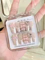 Detail of handmade press-on nails featuring 3D pink bows, pearls and crystal rhinestones - XS / Ballet Shoe - Mid-Coffin (E09) / Barbie Pink
